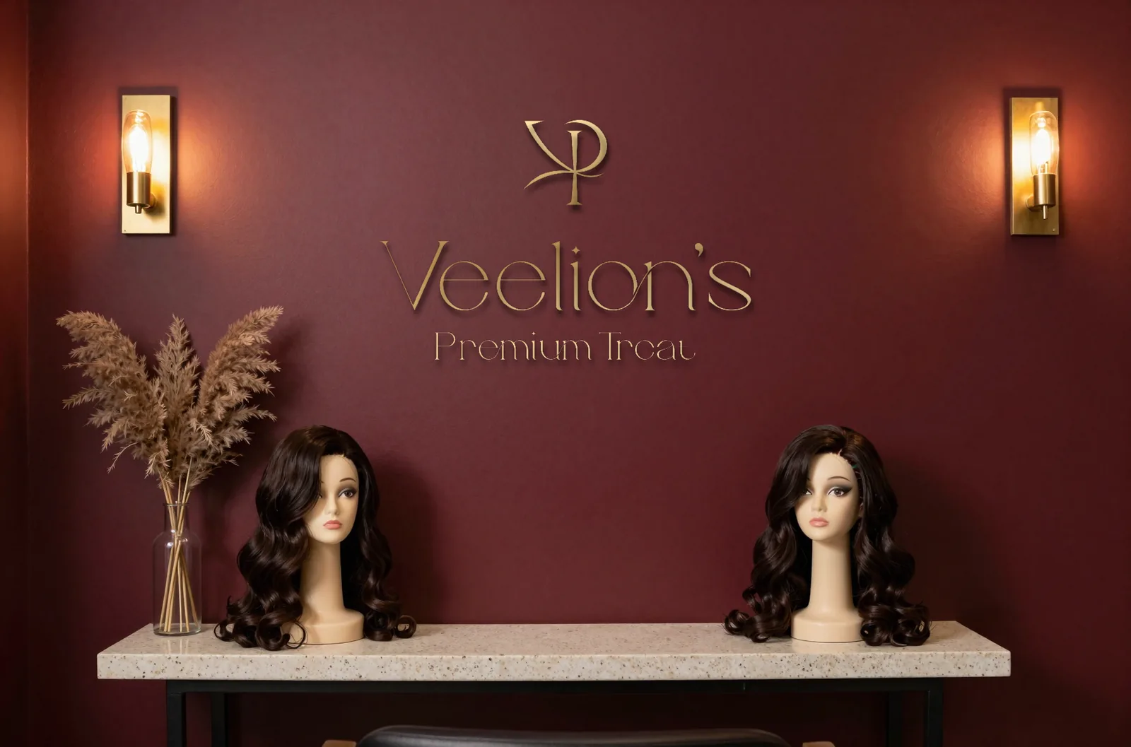 Veelion's studio: the brass lockup on a burgundy wall above a console with two styled wigs